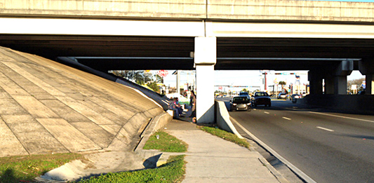 People hanging out under the I-75 overpass at U.S. 90