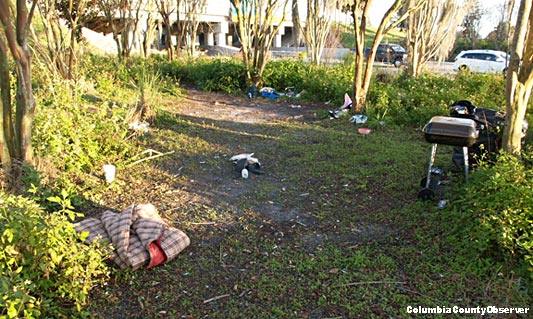 homeless items in the tall grass by the I-75 interchange at U.S. 90