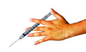 hand holding a syringe to give vaccination