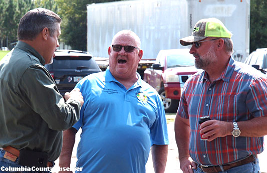 Sheriff Mark Hunter, Commissioner Bucky Nash, and Kevin Kirby share a joke.