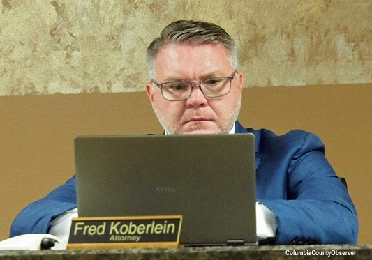 Lake Shore Hospital Authority Attorney Fred Koberlein, Jr., peers into his laptop.