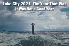 Image of hand coming out of the sea with caption: Lake City 2021, the year that was. It was not a good year