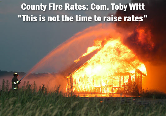 Barn on fire with headline: County Fire Rates, Commissioner Toby Witt, "This is not the time to raise rates."