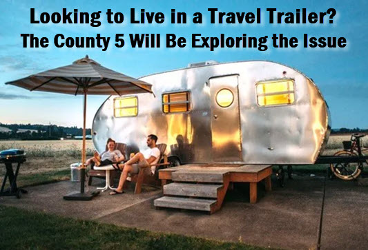 Couple sitting in front of a travel trailer with headline: Looking to live in a travel trailer. The County 5 will be exploring the issue.