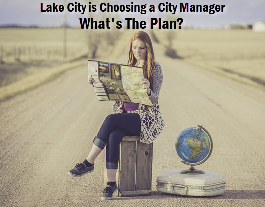 Woman in middle of road with map. Caption: Lake City is choosing a city manager. What's the plan?