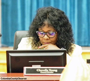 Councilwoman Chevella Young studying the agenda