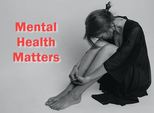 Woman with head on knee with caption: Mental Health Matters