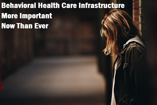 Girl standing in darkened hallway with caption: Behavioral health care infrastructure more important than ever