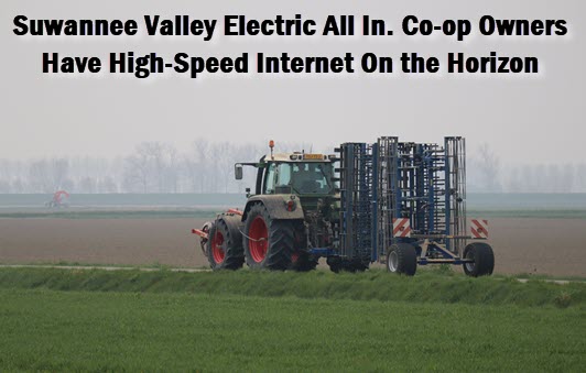 Tractor in field with caption: Suwannee Valley Electric all in. Co-op owners have hight-speed internet on the horizon
