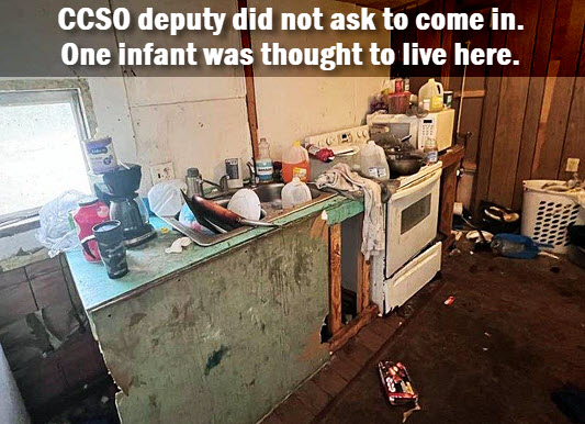 Kitchen area of mobile home with headline: CCSO deputy did not ask to com in. One infant was thought to live there.