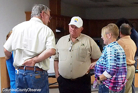 South End utility representative Carl King speaks with County Commissioner Everett Phillips and Terri Thorton.