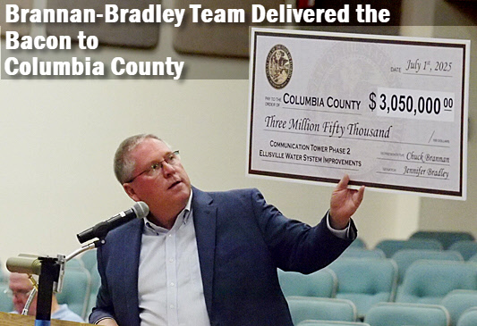 Representative Chuck Brannan holds up 3 million dollar check