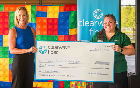 Clearwave Fiber presents check to Girl Scouts