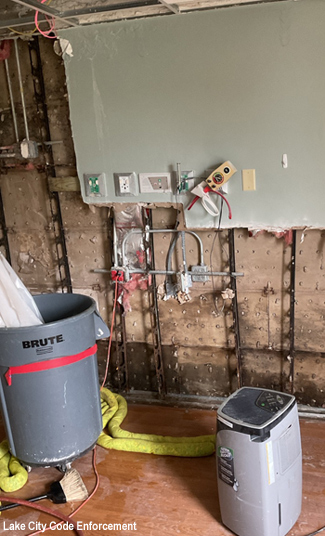 Massive damage inside the Hospital covered up by the Authority Board and Exec. Dir. Here you see a Visine shoot directing water into a bucket and then being pumped out. Notice the black mold at the bottom of the wall.