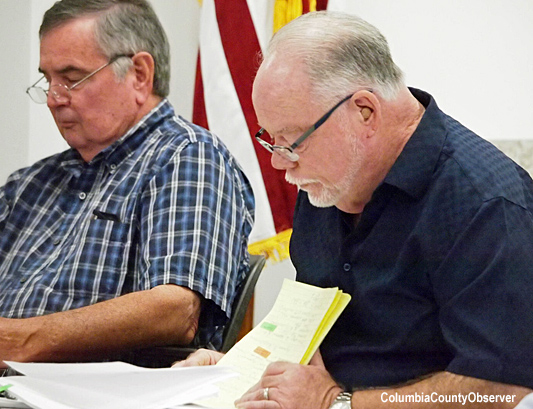 Jock Phelps reviews his notes while questioning Richard Powell